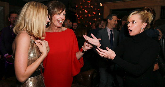 Two women at an event, creating buzz due to their similar appearance, with a surprised expression from onlookers. Two women at an event, creating buzz due to their similar appearance, with a surprised expression from onlookers.