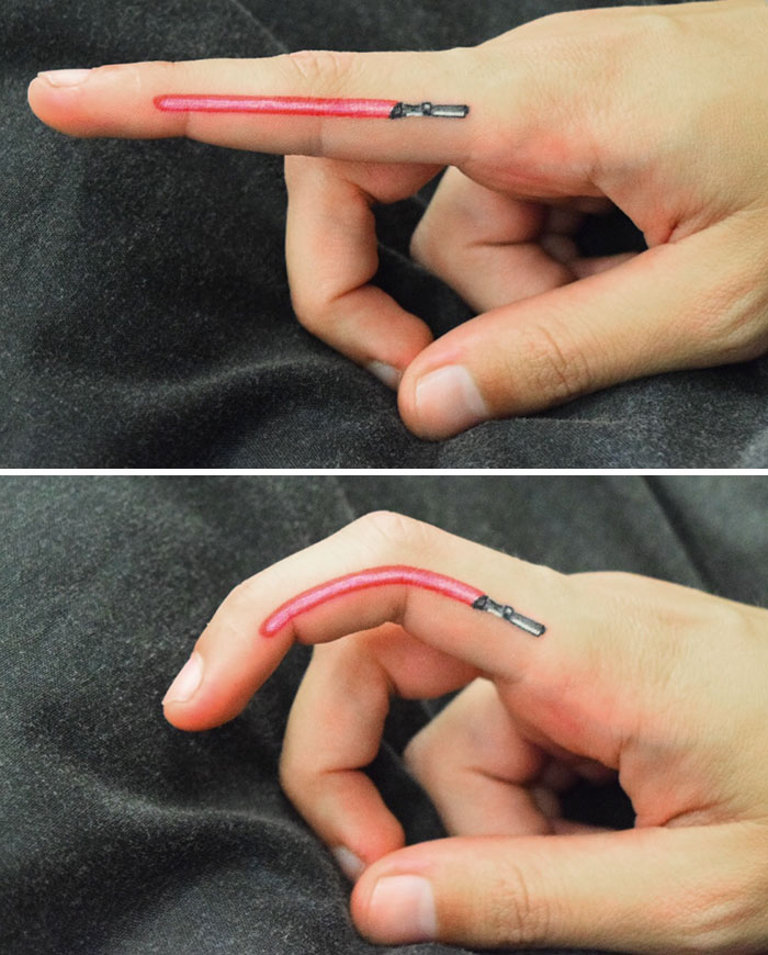 Finger tattoo of a lightsaber on index finger, a trendy design idea.