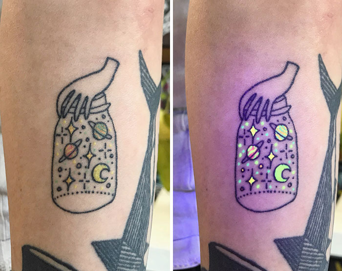 UV tattoo of a jar with planets and stars, glowing brightly under blacklight.