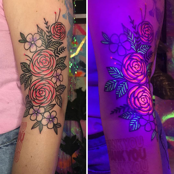 Floral UV tattoo design on an arm, glowing under blacklight.