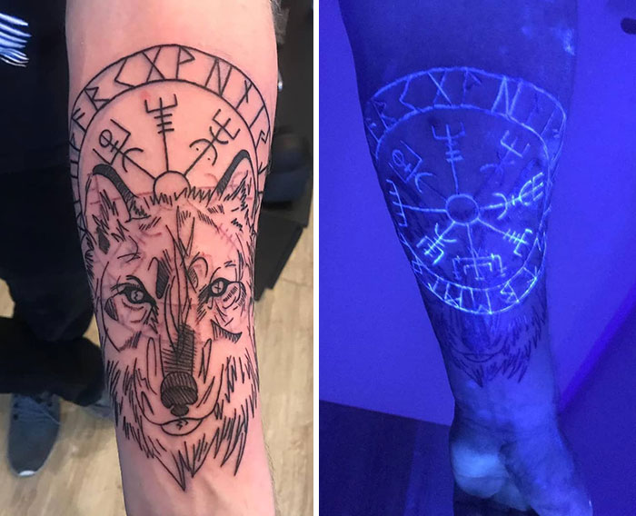 UV tattoo design featuring a wolf and rune symbols, glowing under blacklight on a forearm.