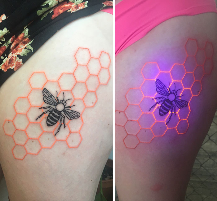 Bee and honeycomb UV tattoo glowing under black light, enhancing the design's vibrancy.