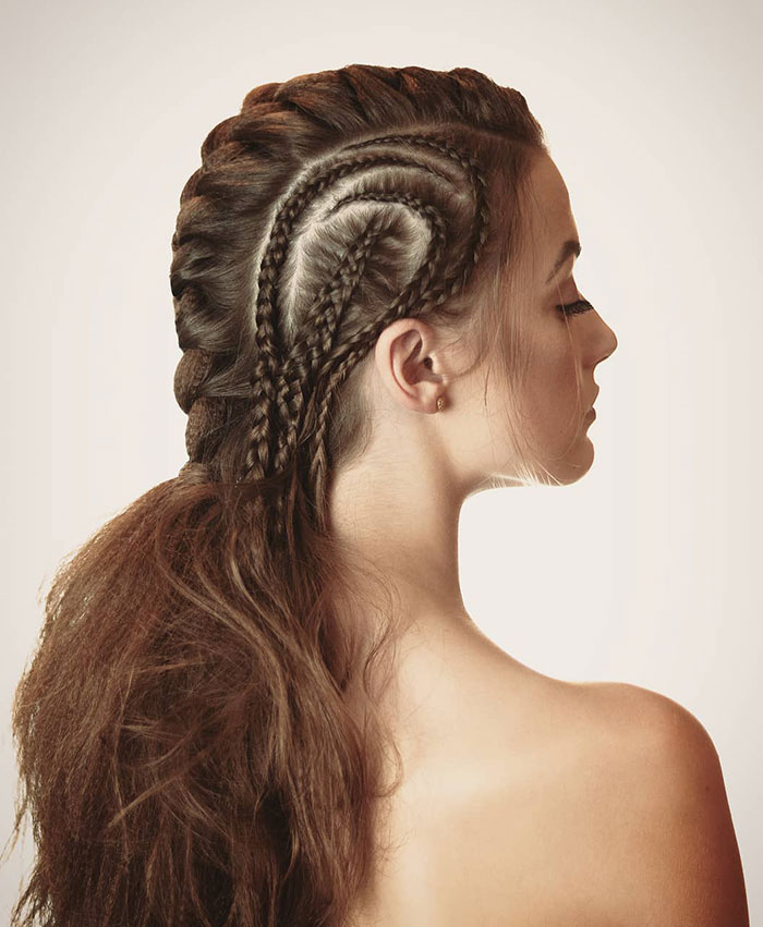 Woman with intricate Viking hairstyle featuring braids, styled for modern-day Valkyries.