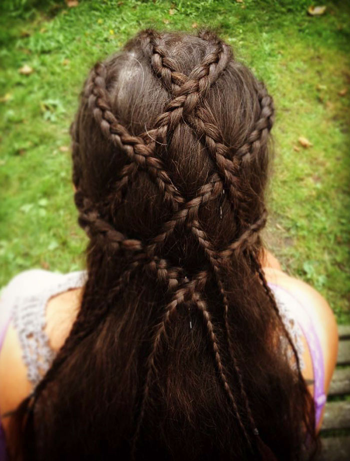 Intricate Viking braided hairstyle for modern Valkyries, showcasing complex patterns and long dark hair.
