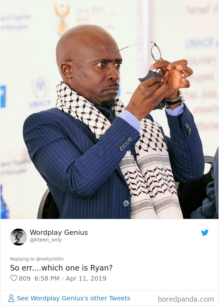 Man adjusting glasses wearing pinstripe suit and patterned scarf, linked to Ryan Gosling lookalike discussion online. Man adjusting glasses wearing pinstripe suit and patterned scarf, linked to Ryan Gosling lookalike discussion online.