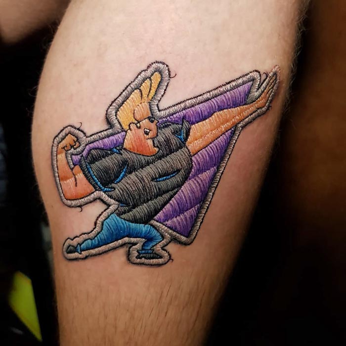 Embroidery tattoo of a cartoon character with bold colors on skin, showcasing Brazilian tattoo artistry.