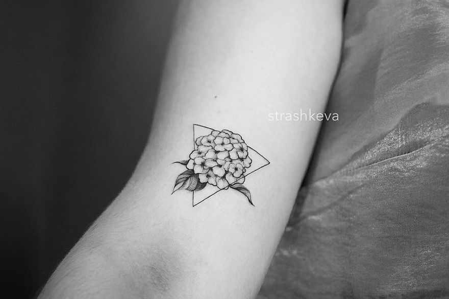Floral tattoo design by Lublin artist, featuring a geometric shape on the arm.