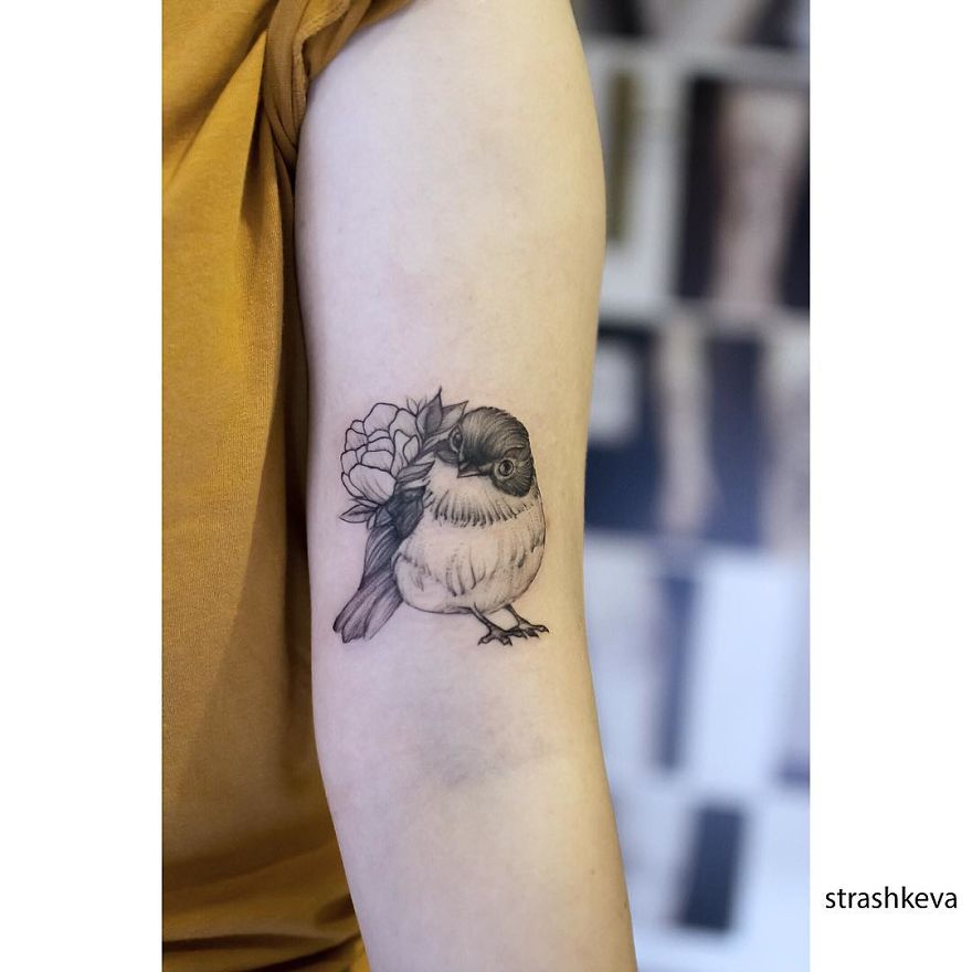 Bird tattoo on arm by Lublin tattoo artist, featuring detailed shading and floral elements.
