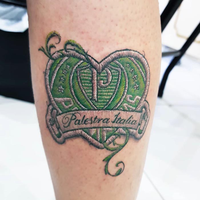 Embroidery tattoo of a green heart with "Palestra Italia" banner by Brazilian artist.