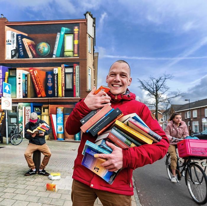 Dutch Artists Paint Giant Bookcase On An Apartment Building Featuring Residents' Favorite Books Dutch Artists Paint Giant Bookcase On An Apartment Building Featuring Residents' Favorite Books