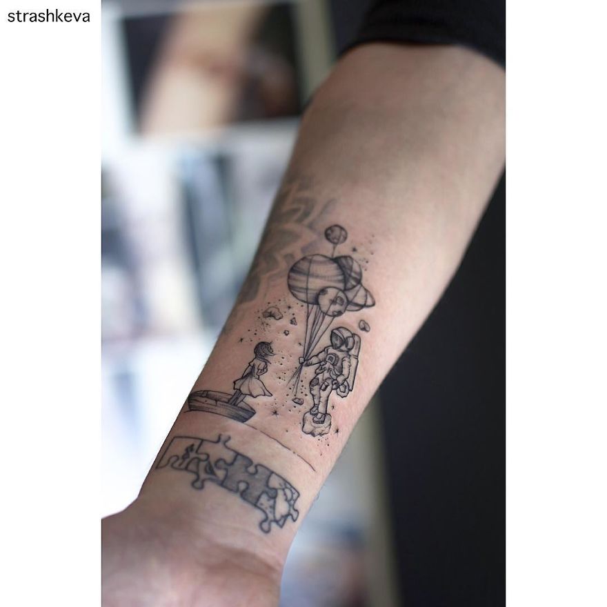 Tattoo art from Lublin, Poland, featuring a space-themed design with an astronaut and planets on a person's forearm.