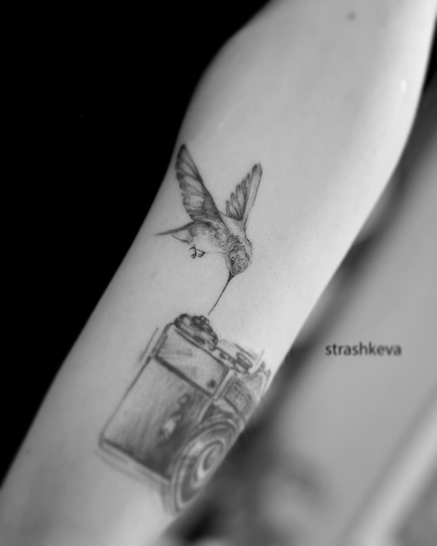 Tattoo of a hummingbird and vintage camera by a Lublin, Poland, artist on an arm.