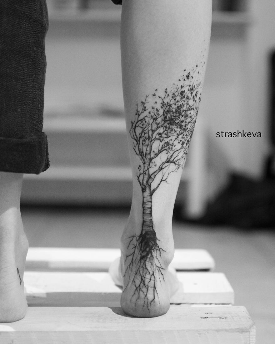 Tattoo artist from Lublin, Poland creates intricate tree design on back of leg.