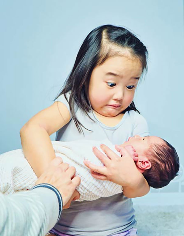 My Daughter's Reaction When Holding Her New Baby Sister. Much Heavier Than The Dolls She Practiced On