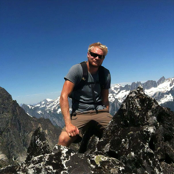 This Picture Of A Friend Hiking Makes Him Look Like A Giant Sitting Amongst Mountains