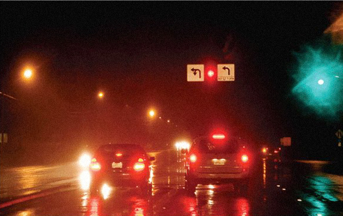 Night driving with astigmatism causing blurry lights and reflections, showing contrast with normal sight clarity. Night driving with astigmatism causing blurry lights and reflections, showing contrast with normal sight clarity.