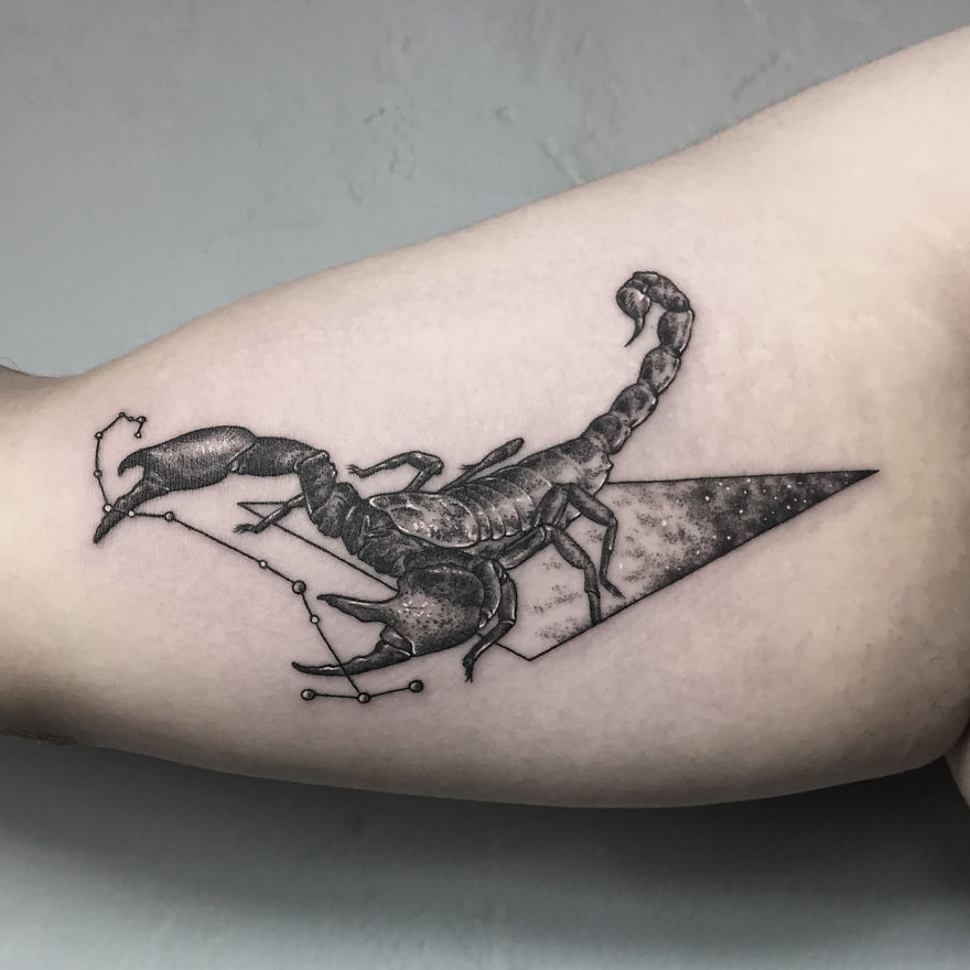 A geometric tattoo featuring a detailed scorpion design, symbolizing life events.