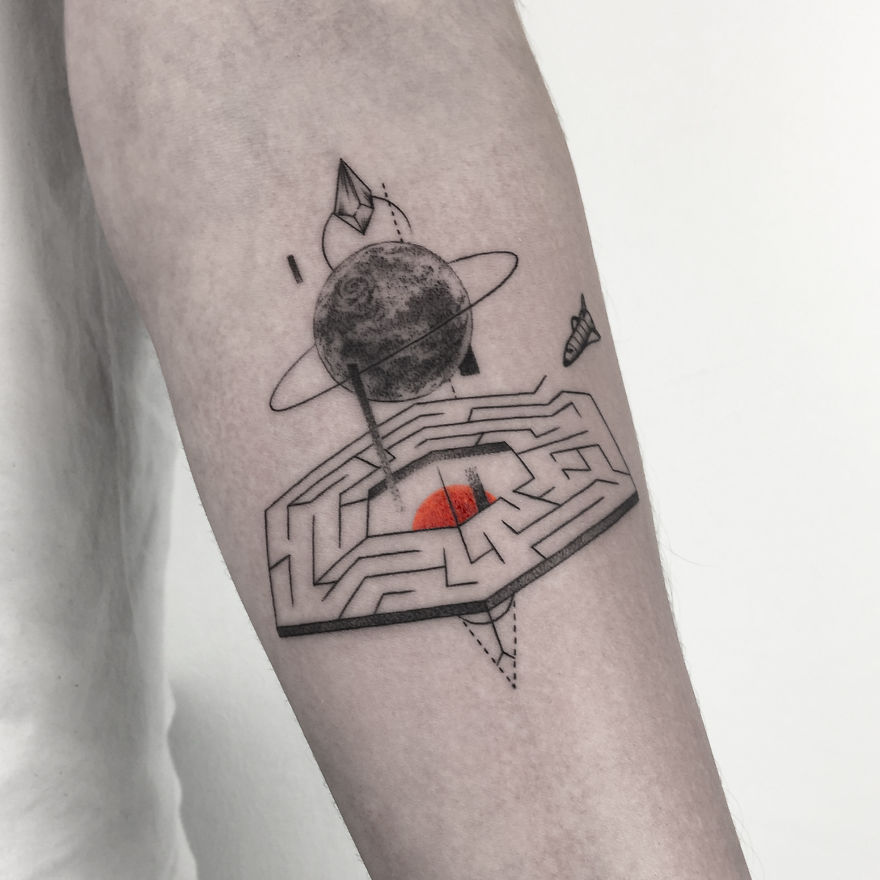 Geometric tattoo featuring a planet and maze design on an arm, symbolizing life events.
