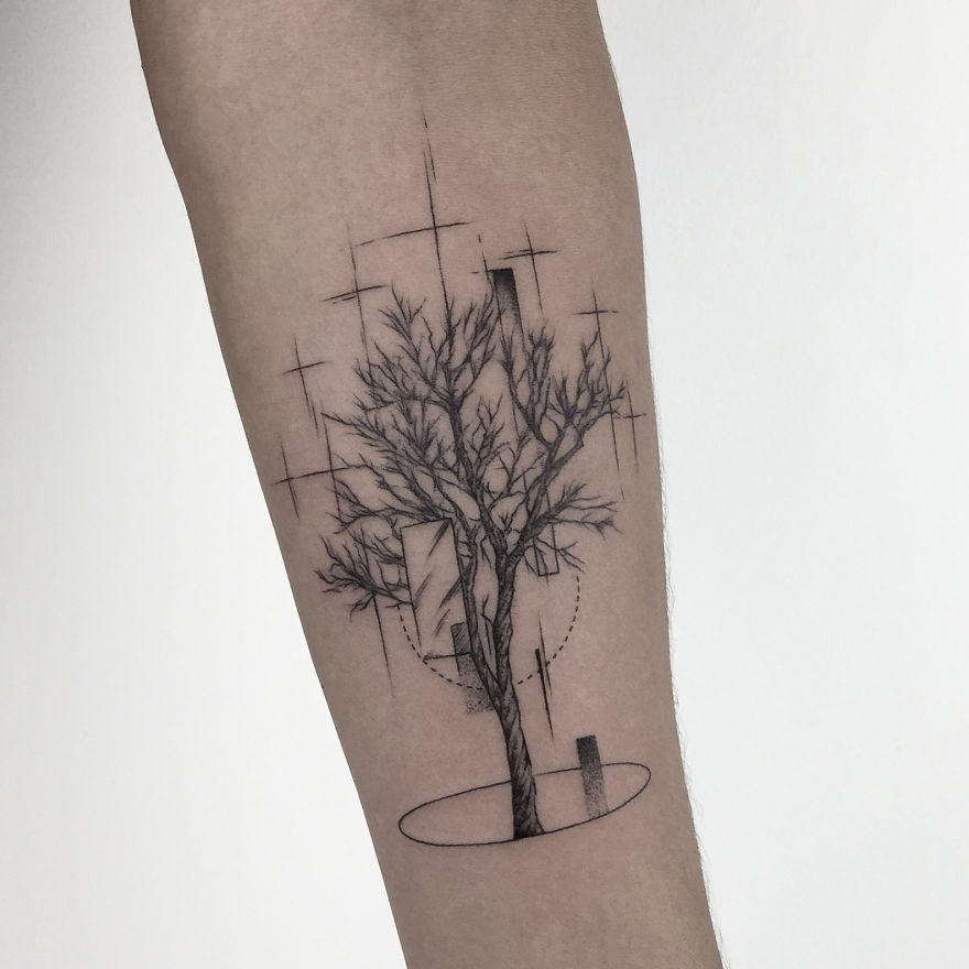 Geometric tattoo design of a tree with abstract elements on an arm, reflecting personal life events.