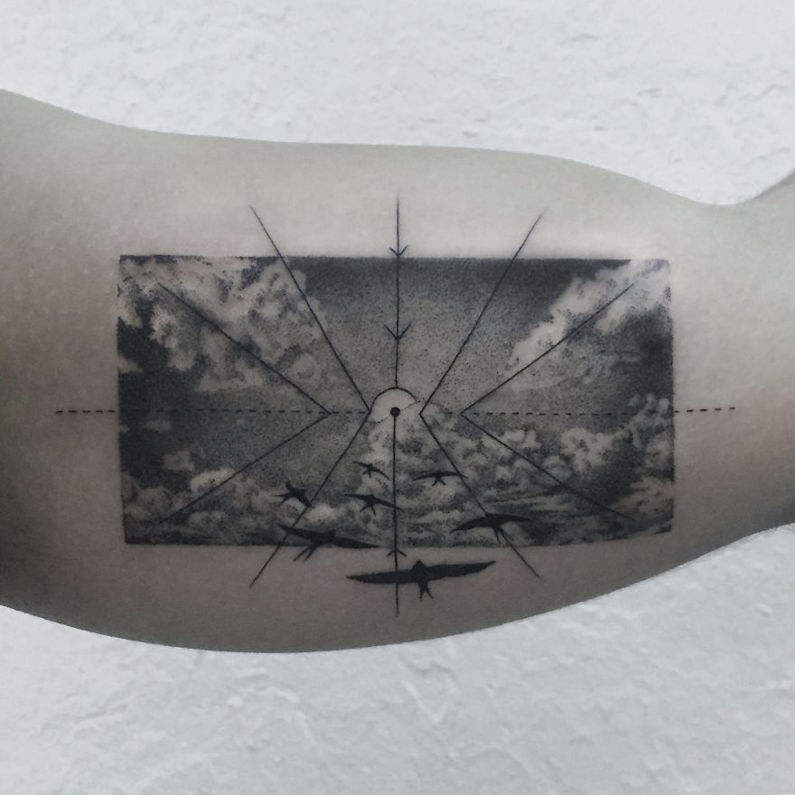 Geometric tattoo design depicting planes flying through stormy clouds with radial lines on a person's arm.
