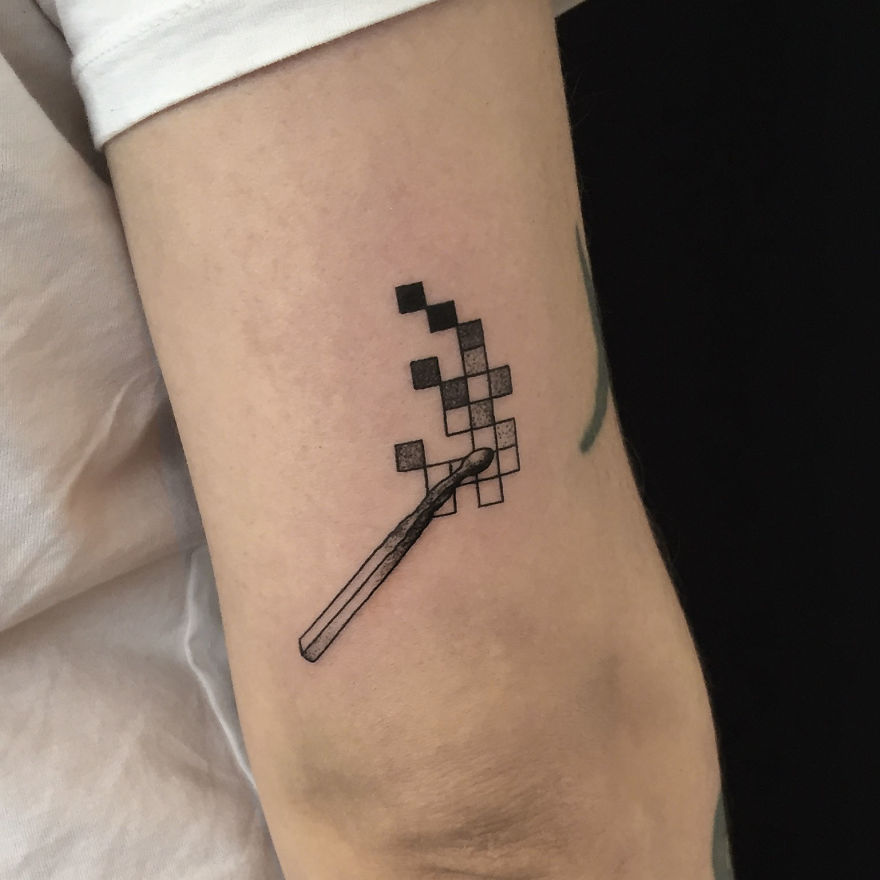 Geometric tattoo design on an arm depicting a wand with pixelated squares.