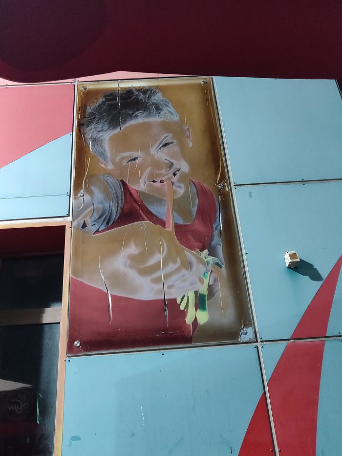 This Worn Out Poster Of A Kid Eating Gummy Worms On The Wall Of My Local Gas Station