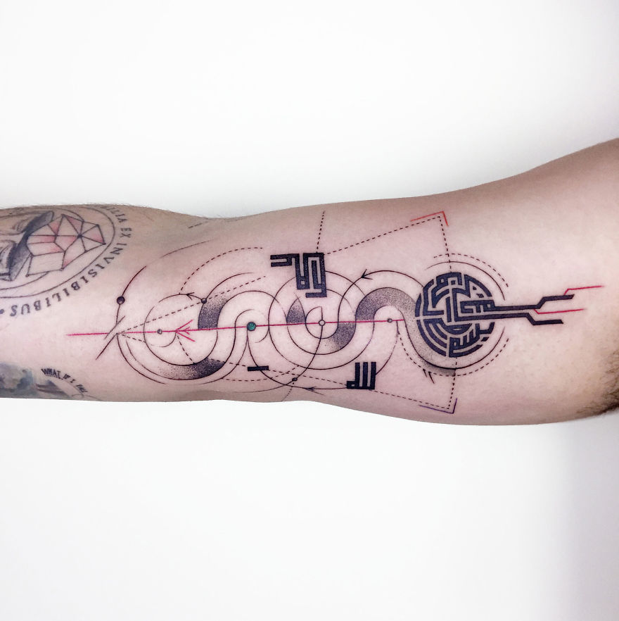 Geometric tattoo design with intricate circles and lines on a forearm reflecting life events.