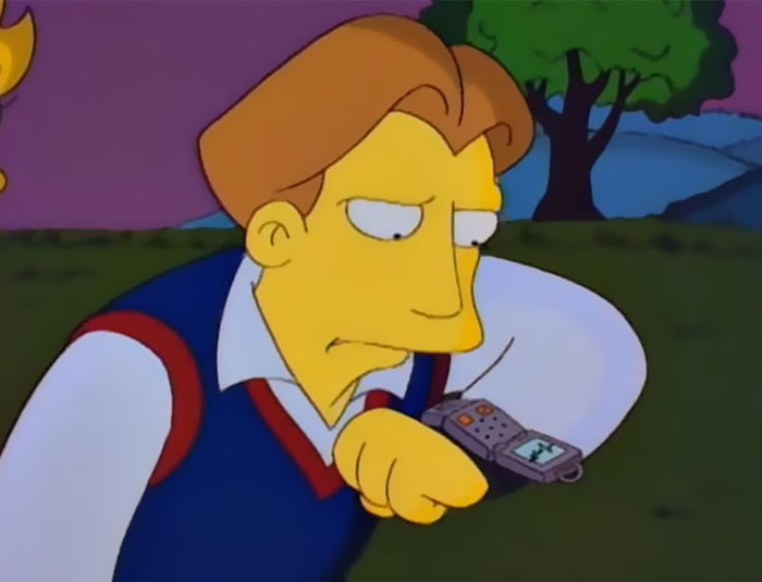 Cartoon character looking at a futuristic wrist device, illustrating how cartoons guessed what will happen in the future.