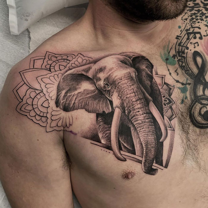 Elephant-themed chest tattoo with intricate patterns, showcasing incredible chest tattoo ideas.