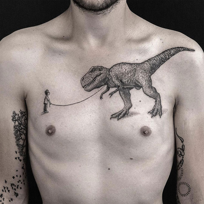 Incredible chest tattoo of a T-rex on a man's chest, showcasing unique tattoo design ideas.