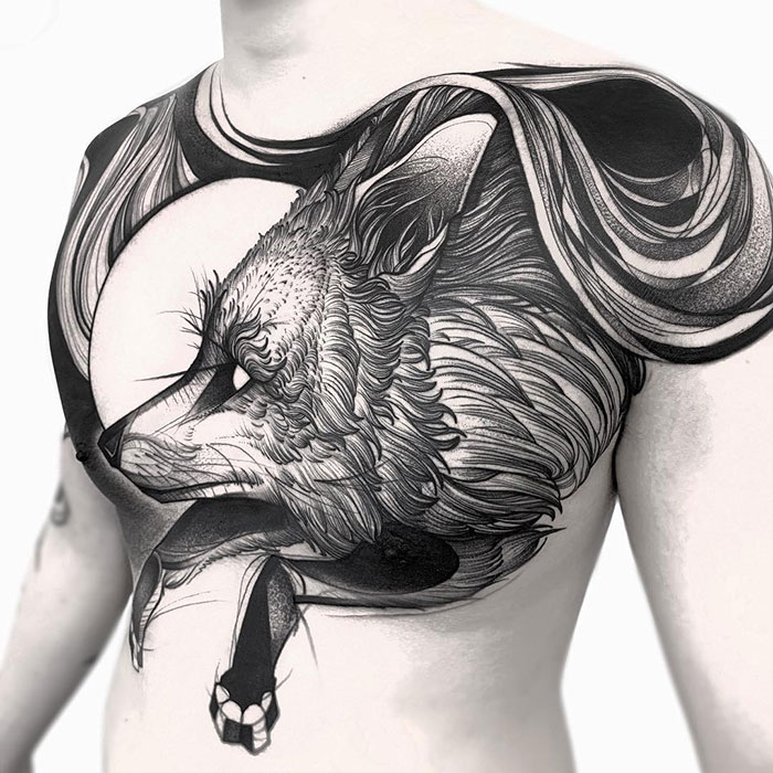 Intricate chest tattoo design featuring a detailed wolf, showcasing incredible tattoo artistry.