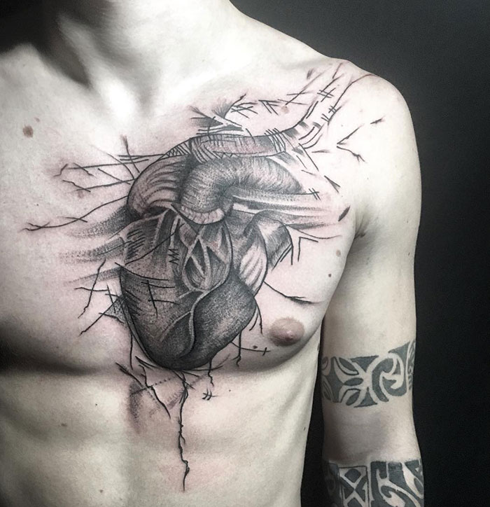 Incredible chest tattoo featuring a detailed anatomical heart design.