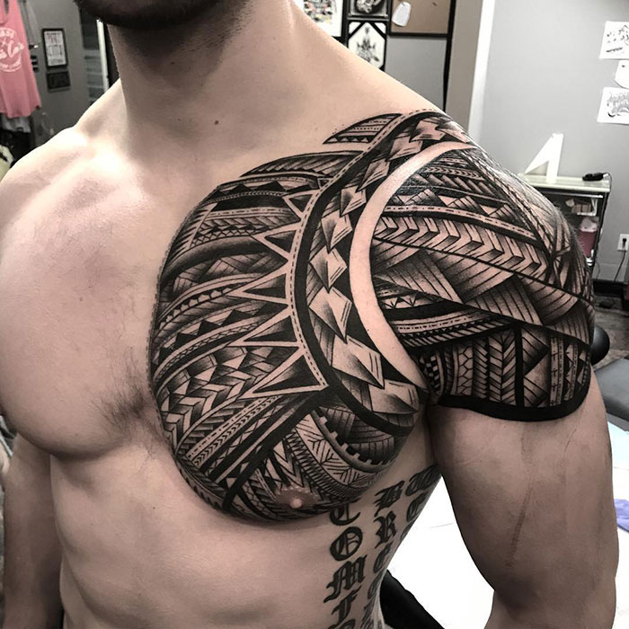 Incredible chest tattoo design featuring bold tribal patterns and intricate details.