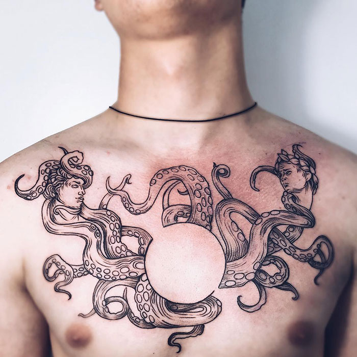 Chest tattoo idea featuring intricate octopus design with human faces, showcasing incredible artistry and detail.