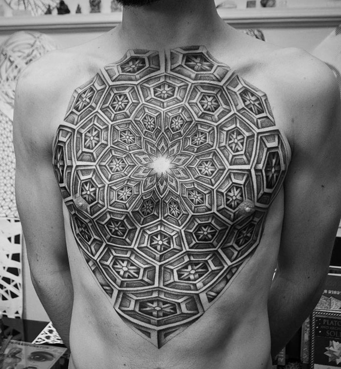 Intricate geometric chest tattoo design, showcasing an incredible ink pattern over the chest area.