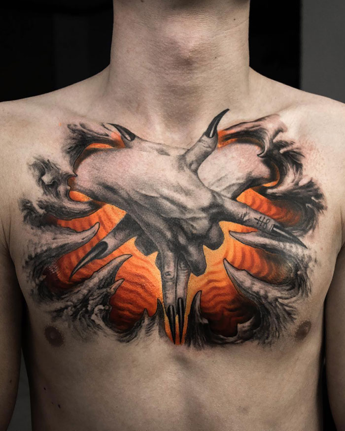 Incredible chest tattoo with a hand and fiery design, showcasing bold ink art.