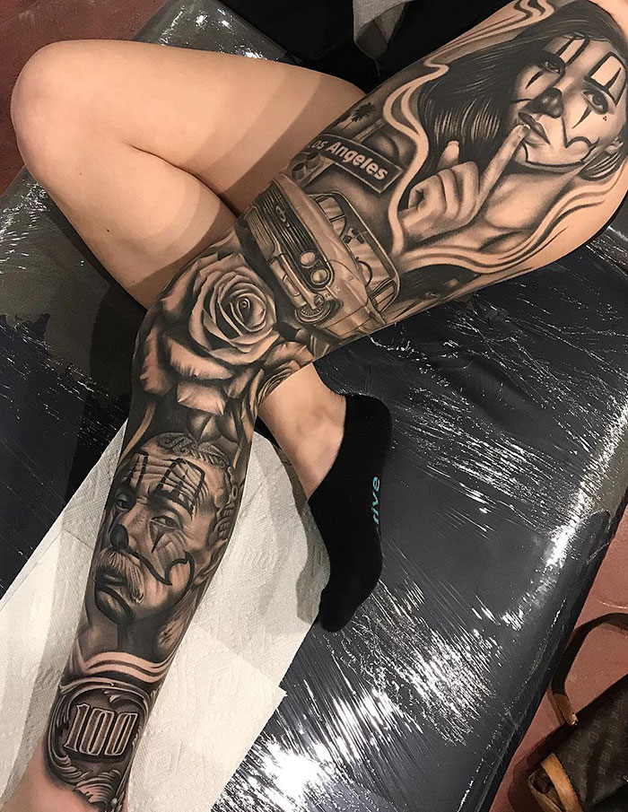 Intricate leg sleeve tattoo featuring a clown face, a rose, a car, and other detailed designs.