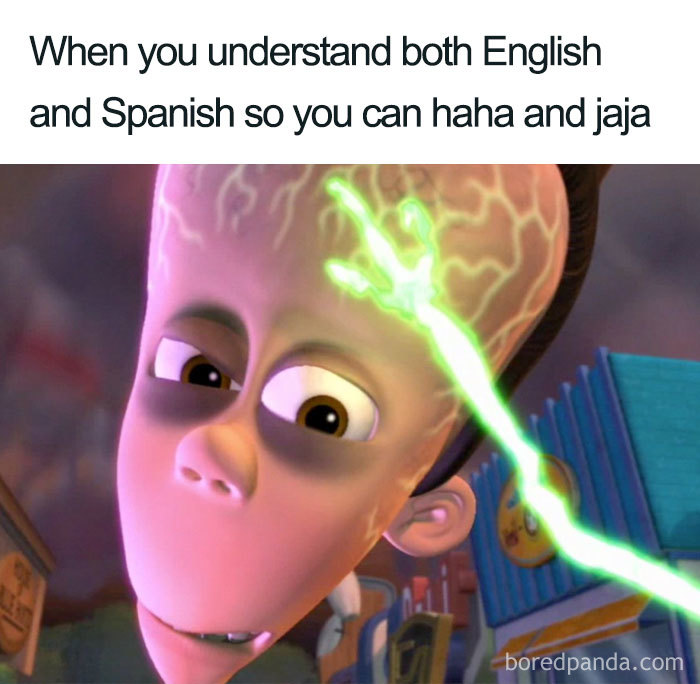 Animated character with glowing brain captioned about understanding English and Spanish in a funny Spanish language meme.