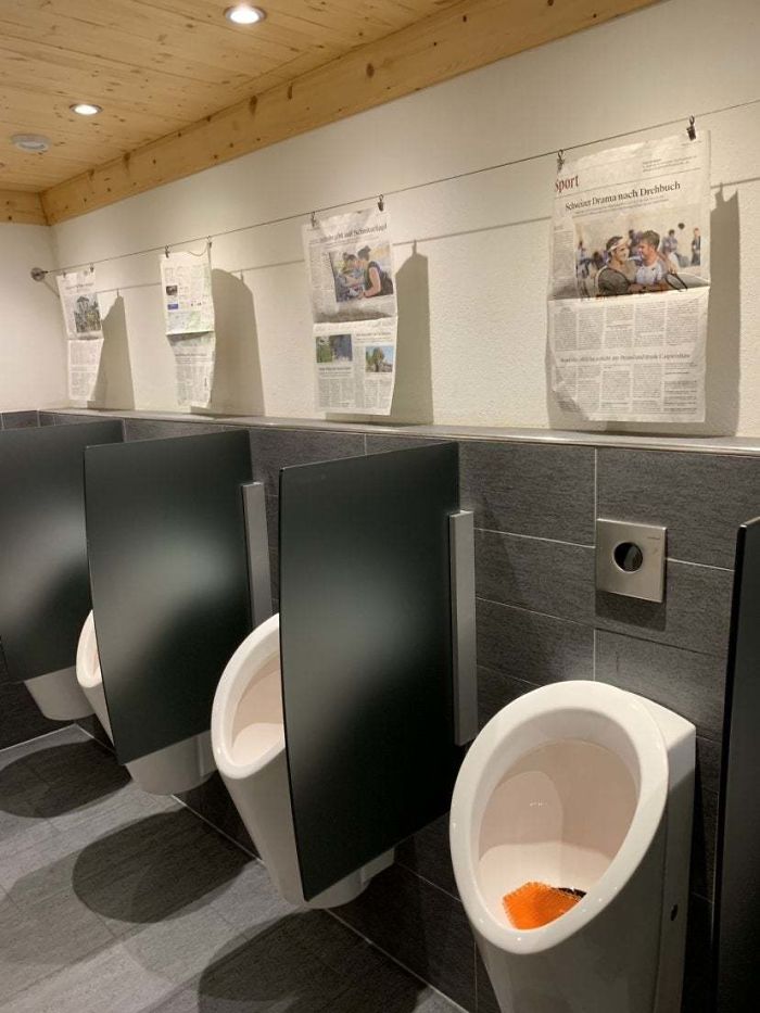 This Swiss Hotel Hangs Up Newspaper Articles At The Urinals For Users