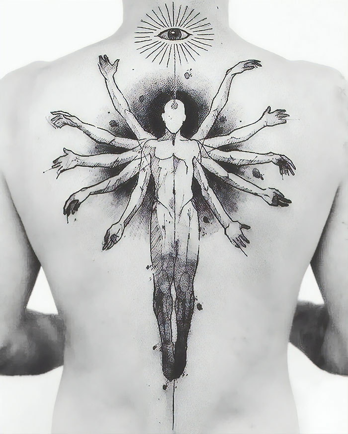 Impressive back tattoo featuring a multi-armed figure with an eye above, showcasing artistic detail and creativity.
