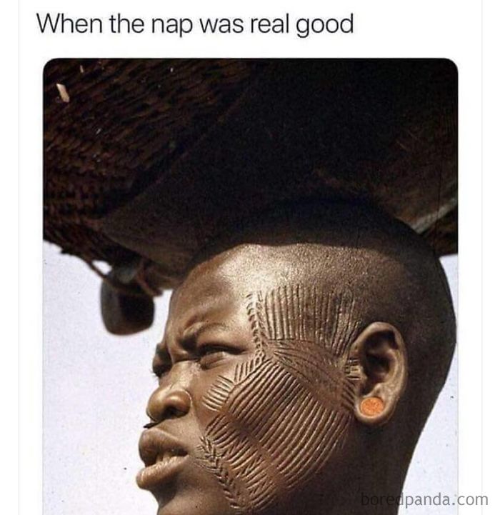 Man with intricate face scarification squinting, capturing a funny sleeping meme about a very good nap experience.