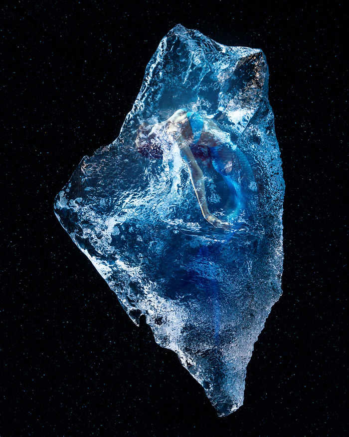 Surreal photo of a person encased in a translucent ice-like structure against a starry backdrop.