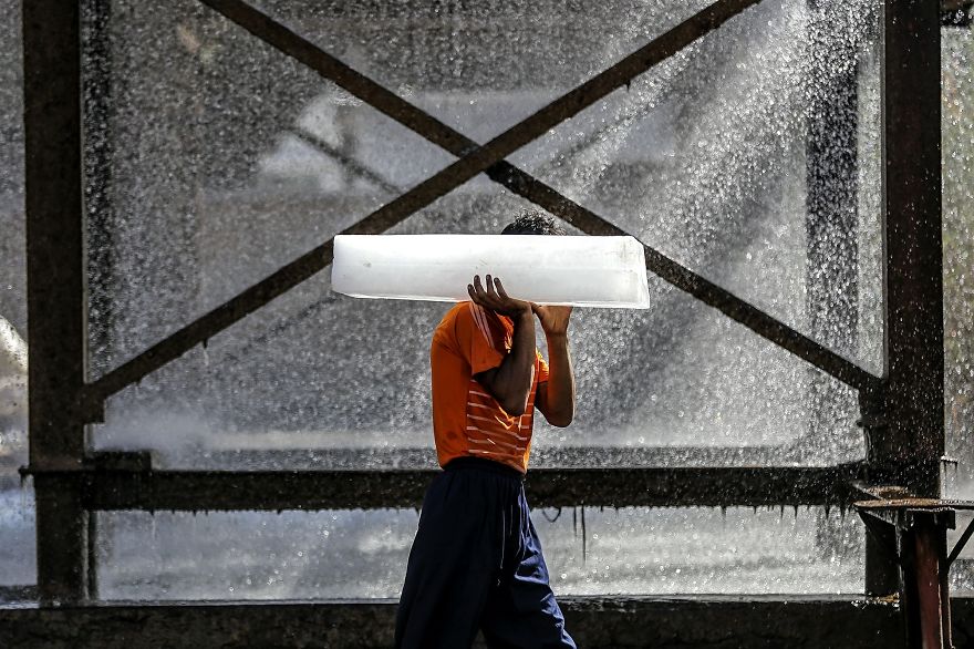 The Workman Moves The Ice To The Car