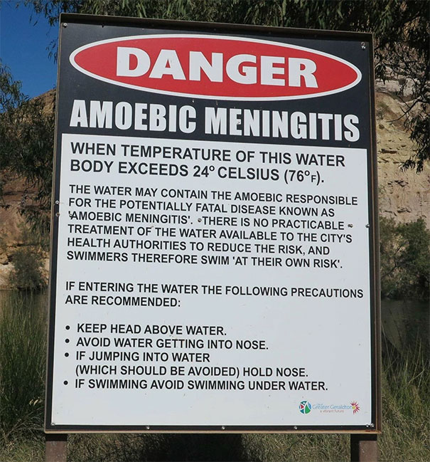 Warning sign in Australia about amoebic meningitis risk in water above 24°C, highlighting the land of nope hazards.