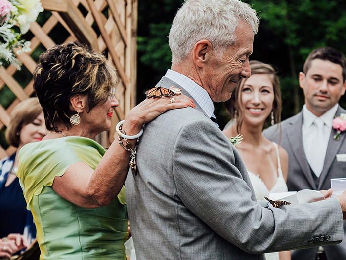 Groom’s family releases butterflies during wedding to honor sister, one butterfly lands on father’s hand. Groom’s family releases butterflies during wedding to honor sister, one butterfly lands on father’s hand.