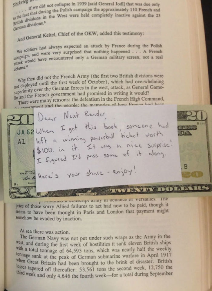 Open book with a $20 bill and handwritten note tucked inside — surprise find in second-hand books