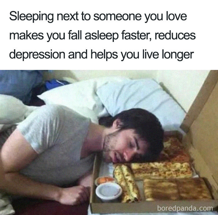 A man sleeps with his head resting on a pizza box, illustrating a funny sleeping meme.
