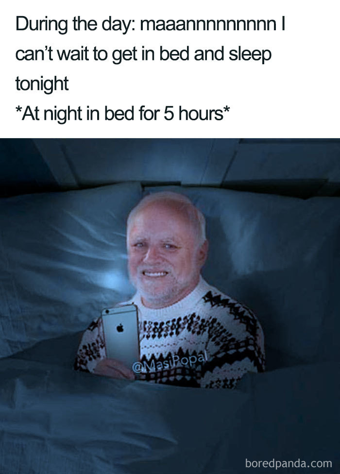 Man in bed using a smartphone at night with a reluctant smile, illustrating funny sleeping memes and bedtime struggles.