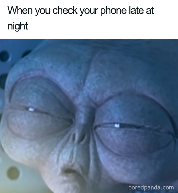 Close-up of a tired alien face with eyes half-open, representing the feeling of checking phone late at night in funny sleeping memes.
