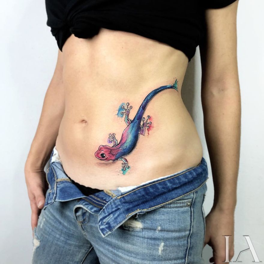 Colorful lizard tattoo by Turkish artist on a person's side, showcasing intricate animal design.
